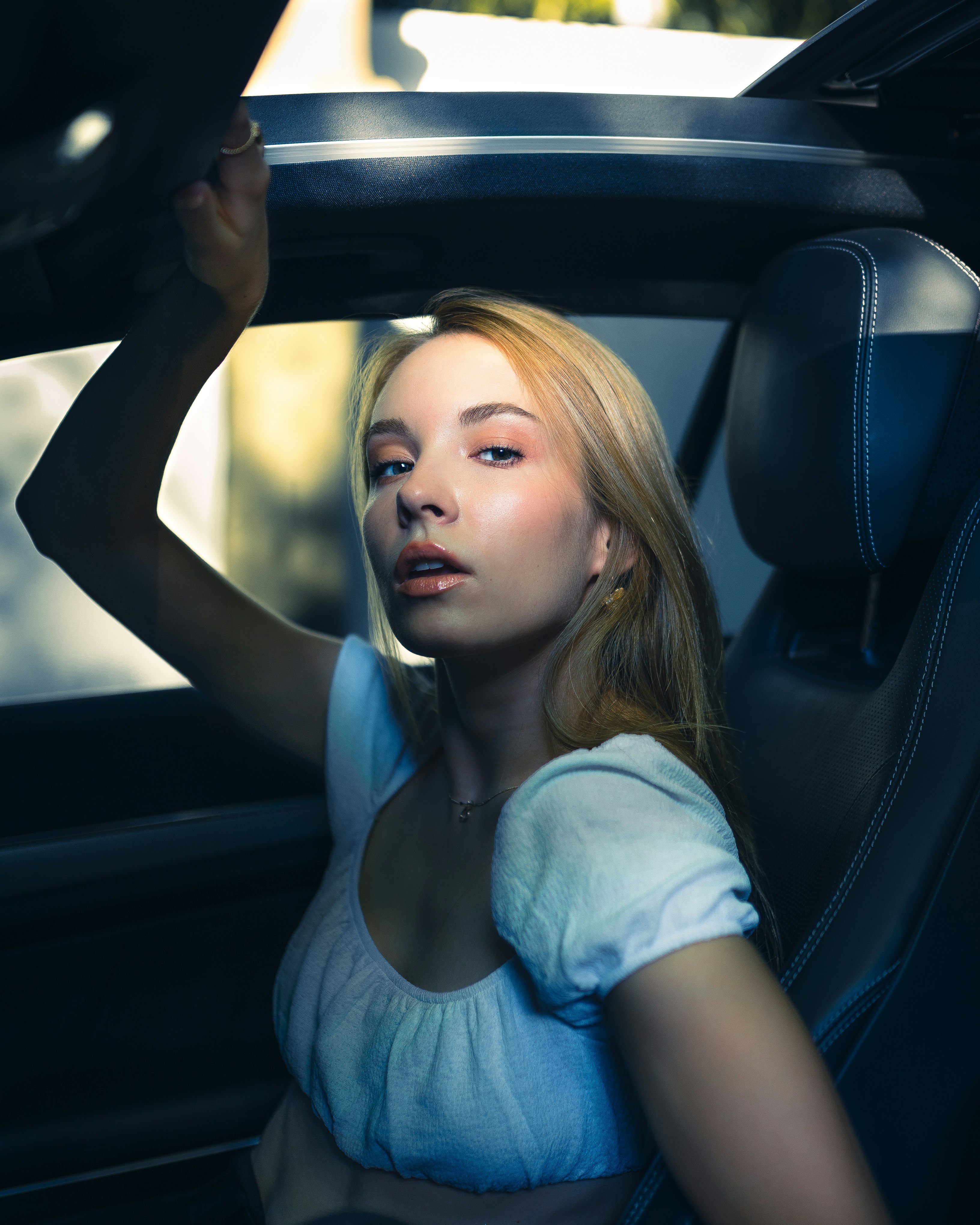 girl in white shirt sitting on car seat